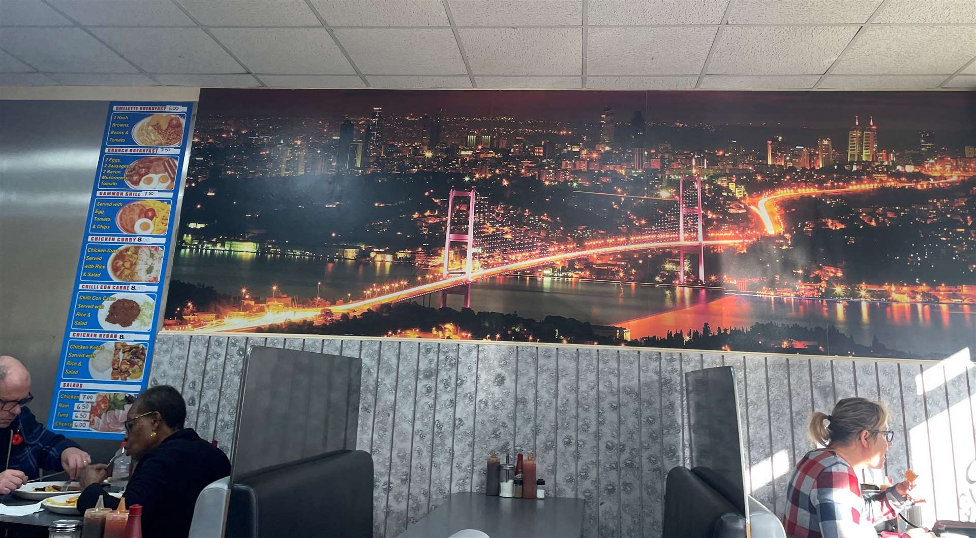 There were multiple canvases of cities around the cafe