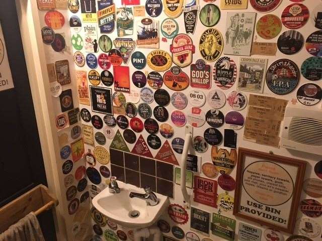 Decoration with a difference, just about every inch of the toilet walls was covered by beer mats. There was hardly room for the mini sink. (59653708)