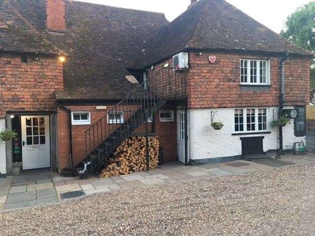 There is a large shale-covered car park to one side of the pub and visitors can get into the pub through the door to the left hand side of that impressive log pile.