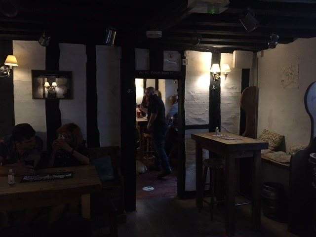 Heavily beamed walls and ceilings are complemented by equally heavy wooden tables and chairs. The three biggest bores you’re ever likely to meet had just left before I took this very dark picture of the inside of the pub.