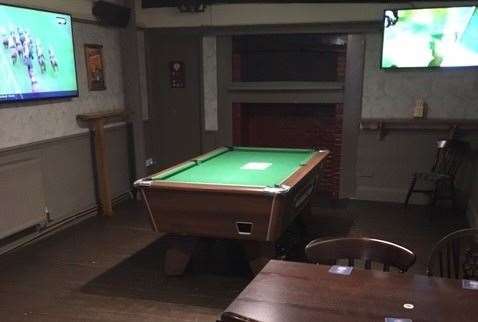 The pool table had an out-of-order sign on it but the TV in the side room continued to perform to an indifferent audience