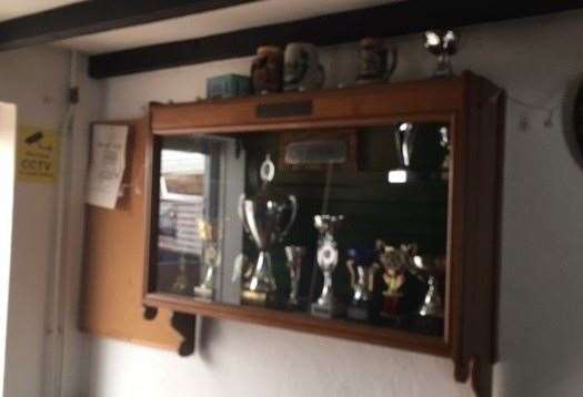 Not my best photograph, but the trophies in this dark brown wooden cabinet suggest the pub has its fair share of decent darts players