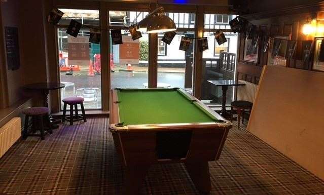 It wasn’t in use, but someone had removed one of two pool table’s wooden covers