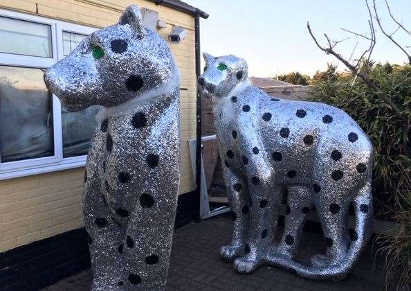 Two giant shiny silver cats, to be found at the back of the pub
