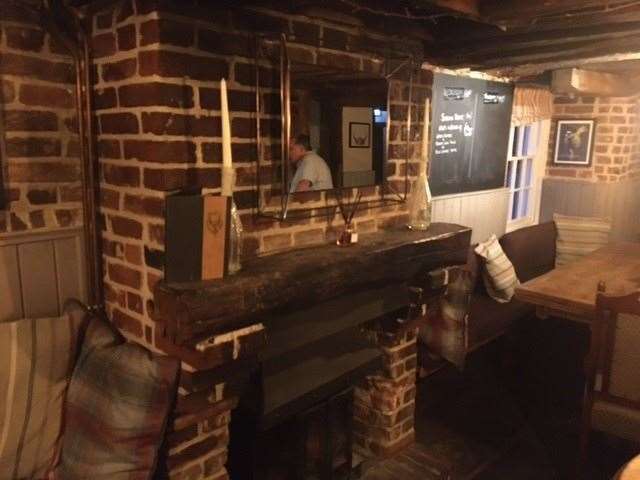 The pub features plenty of candles – not only on each table but also on a beam across the fireplace.
