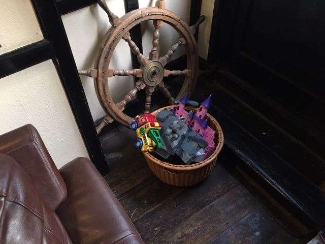 Behind my perfect sofa spot, alongside the ship’s wheel, was a collection of kids toys and when I returned I’m pleased to say they were all in use