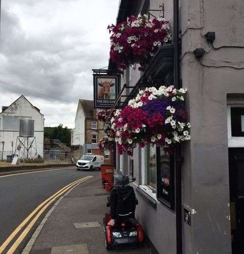 The hanging baskets at the front of the pub must have been well watered during this warm spell. I’m not sure who travelled to the pub on a mobility scooter, but they certainly parked it neatly.
