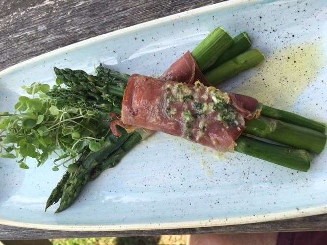 Local asparagus wrapped in Parma ham and cooked in garlic butter - absolutely delicious