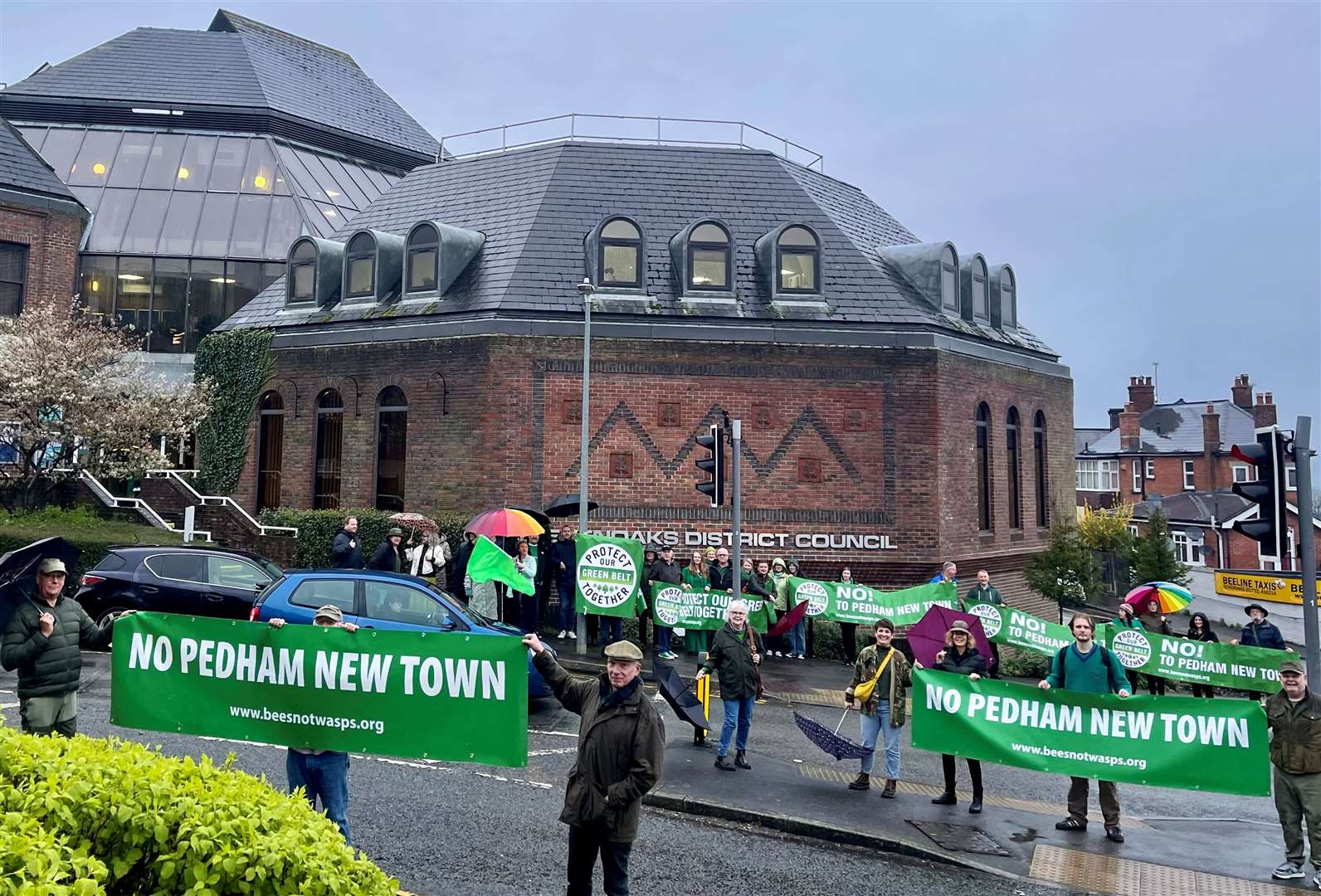 More than 50 villagers braved the rain to join a protest outside Sevenoaks council over plans to build a 2,500 home garden village at Pedham Place golf course. Photo: Protect The Green Belt Together