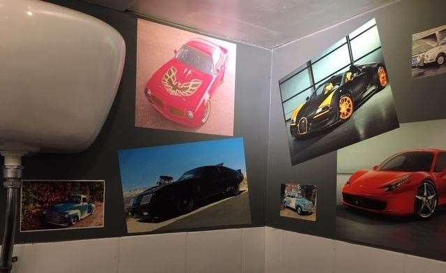 Racy looking cars featured on the wall of the gents