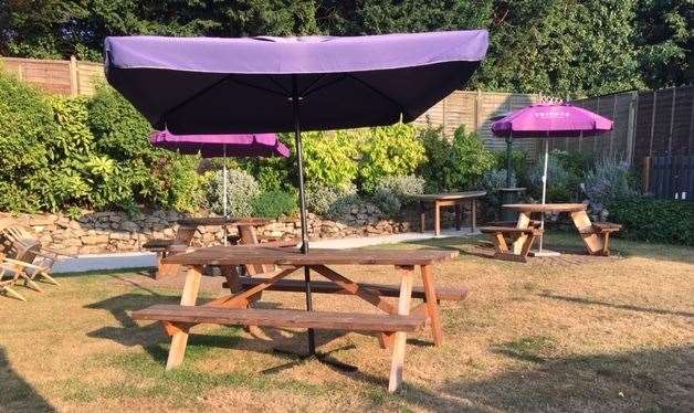 The picnic benches in the well-maintained garden have purple Tribute umbrellas to provide some respite from this summer’s strong sunshine