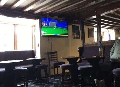 There are plenty of exposed beams inside the pub – the big screen was showing snooker